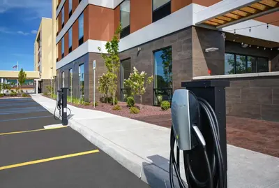 a row of parking meters in front of a building at Home2 Suites By Hilton Utica, Ny in Utica