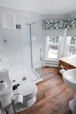 a bathroom with a shower and a toilet and a sink at The Whitlock by The Lenox Collection in Lenox