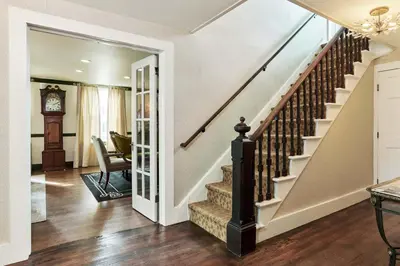 a staircase in a home with a clock at The Whitlock by The Lenox Collection in Lenox