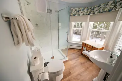 a bathroom with a shower and a toilet and a sink at The Whitlock by The Lenox Collection in Lenox