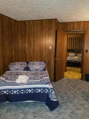 a bedroom with a bed with a white towel on it at Saw Creek Cabin - Regent Hilltop in Bushkill