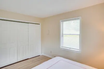 a bedroom with a bed and a window at Peaceful Catskills Condo with Deck and Mountain View! in Windham