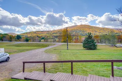 a car parked on a road in front of a mountain at Peaceful Catskills Condo with Deck and Mountain View! in Windham