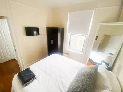a bedroom with a bed with a book on it at 2 Bedrooms Entire Beautiful Apt in Williamsburg! in Brooklyn