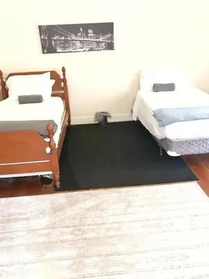two beds sitting next to each other in a room at 1950s Charm In The Heart Of Waterbury in Waterbury