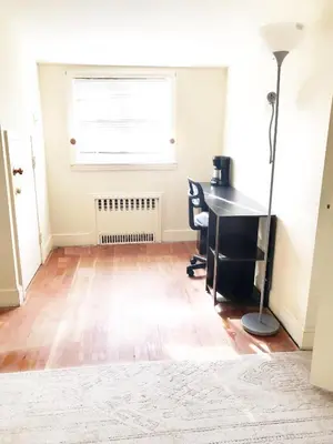 an empty office with a desk and a window at 1950s Charm In The Heart Of Waterbury in Waterbury