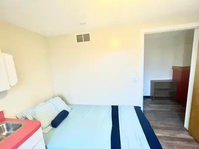 a small room with a bed and a sink at 1950s Charm In The Heart Of Waterbury in Waterbury