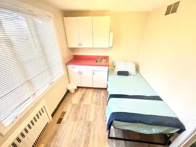 a small room with a bed and a window at 1950s Charm In The Heart Of Waterbury in Waterbury