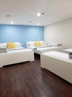 a room with four beds with yellow pillows at Hotel and the City, Empire State Building in New York