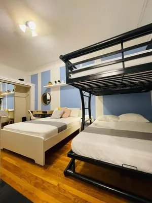 a bedroom with two bunk beds and a desk at Hotel and the City, Empire State Building in New York