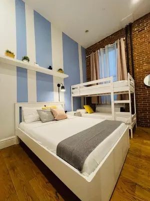 a bedroom with two bunk beds and blue and white stripes at Hotel and the City, Empire State Building in New York