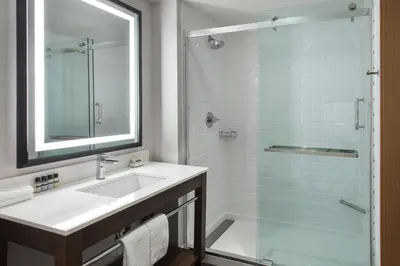 a bathroom with a sink and a shower at Four Points by Sheraton Albany in Albany