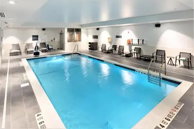 a large swimming pool in a hotel room at Four Points by Sheraton Albany in Albany