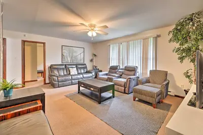 a living room with leather furniture and a ceiling fan at PoolandBeach Access Spacious Tobyhanna Family Home! in Tobyhanna