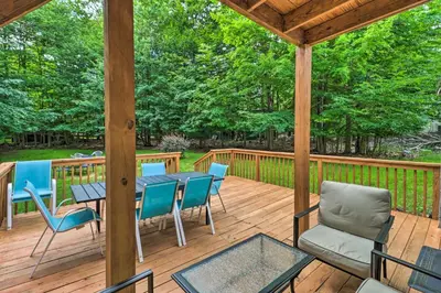 a wooden deck with a table and chairs on it at PoolandBeach Access Spacious Tobyhanna Family Home! in Tobyhanna
