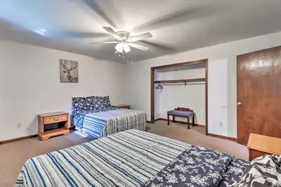 a bedroom with two beds and a ceiling fan at PoolandBeach Access Spacious Tobyhanna Family Home! in Tobyhanna