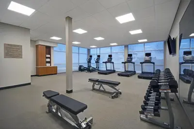 a gym with a row of treadmills and machines at SpringHill Suites by Marriott Hartford Cromwell in Cromwell