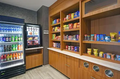 a refrigerator and shelves with food and drinks in a store at SpringHill Suites by Marriott Hartford Cromwell in Cromwell