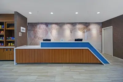 a lobby with a blue counter in a building at SpringHill Suites by Marriott Hartford Cromwell in Cromwell