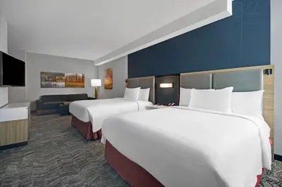 a hotel room with two beds and a couch at SpringHill Suites by Marriott Hartford Cromwell in Cromwell