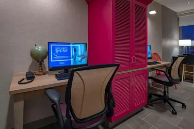an office with pink walls and a desk with a computer at Home2 Suites By Hilton Wayne, NJ in Wayne