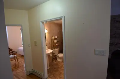 a bathroom with a toilet and a sink at Riverhouse Extended Stay Apartment in Jersey City