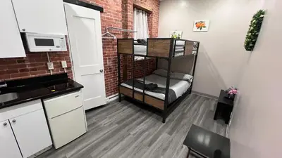 a small kitchen with a shelf in a room at 31 Street Broadway Hotel in New York