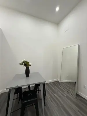 a white room with a table with a vase on it at 31 Street Broadway Hotel in New York