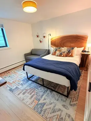 a bedroom with a large bed and a couch at Farm Road Estate in West Dover