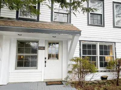 a white front door of a white house at Farm Road Estate in West Dover