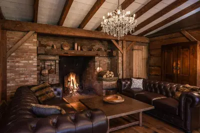 a living room with leather furniture and a fireplace at Farm Road Estate in West Dover