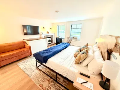 a bedroom with a large bed and a couch at Farm Road Estate in West Dover