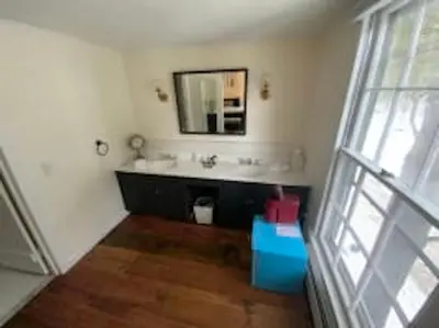 a bathroom with a sink and a mirror at Farm Road Estate in West Dover