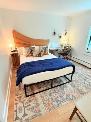 a bedroom with a large bed with a wooden headboard at Farm Road Estate in West Dover