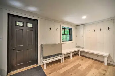 an empty room with a tv and a door at Sleek Cabin with Deck, 8 Miles to Mount Snow and Hikes in Wilmington