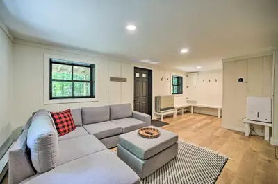 a living room with a couch and a table at Sleek Cabin with Deck, 8 Miles to Mount Snow and Hikes in Wilmington