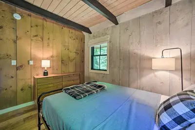 a bedroom with a bed and a desk and a window at Sleek Cabin with Deck, 8 Miles to Mount Snow and Hikes in Wilmington