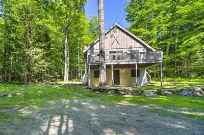 a house in the woods with a balcony at Sleek Cabin with Deck, 8 Miles to Mount Snow and Hikes in Wilmington