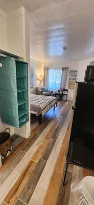 a bedroom with a bed and a couch in a room at Rolling Hills Motel in Wantage