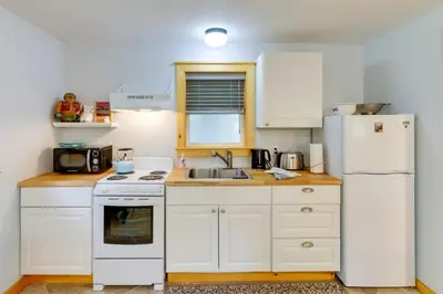 a kitchen with white appliances and a white refrigerator at East Otis Vacation Rental with Private Deck and BBQ! in East Otis