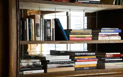 a book shelf filled with lots of books at The Marlton Hotel in New York