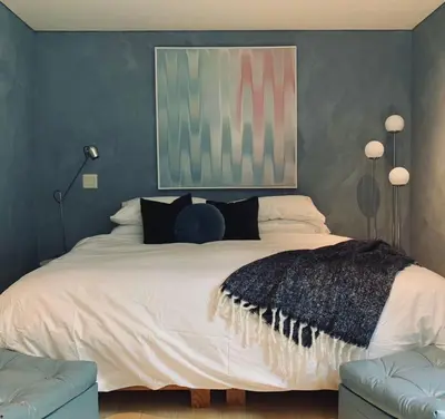 a bedroom with a large white bed with two lamps at The Trail in Adams - Berkshires' Art Hotel in Adams