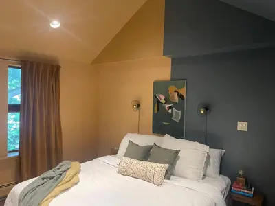 a bedroom with a bed with white sheets and pillows at The Trail in Adams - Berkshires' Art Hotel in Adams