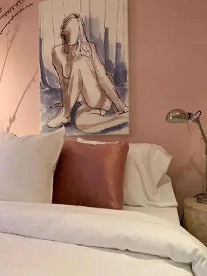 a drawing of a woman sitting on top of a bed at The Trail in Adams - Berkshires' Art Hotel in Adams