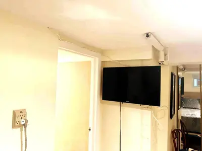 a flat screen tv on a wall in a room at Historical Neighborhood Home in New Rochelle