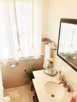 a bathroom with a sink and a mirror at Historical Neighborhood Home in New Rochelle