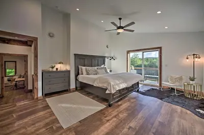 a bedroom with a bed and a ceiling fan at Luxury Home with Deck Explore the Catskill Mtns! in Windham