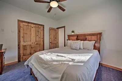 a bedroom with a bed with a ceiling fan at Luxury Home with Deck Explore the Catskill Mtns! in Windham