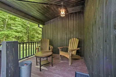 two chairs and a stool sitting on a deck at Luxury Home with Deck Explore the Catskill Mtns! in Windham