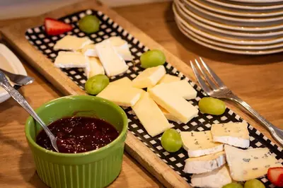 a plate of cheese and jam on a table at Arcady Mountain Motor Lodge in Sunderland